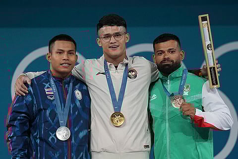Paris Olympics men's 73kg weightlifting: Weeraphon Wichuma of Thailand, silver, Rizki Juniansyah of Indonesia, gold, and Bozhidar Dimitrov Andreev of Bulgaria, bronze